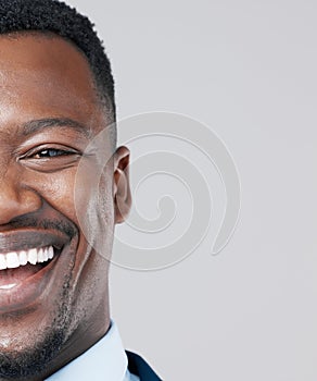 Smile and life smiles back at you. Studio portrait of a young businessman against a grey background.