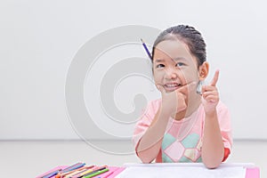 Smile little asian girl with pencil color on white background