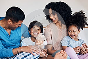 Smile, love and children with their parents on a bed for bonding, connection or playing with toys. Happy, teddy bear and