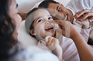 Smile, love and happy family in a bed laughing, bonding and playing in their home together. Face, playful and girl child