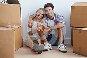 Smile, love and portrait of couple with boxes in new home living room for unpacking and moving together. Happy, relax