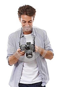 Smile, man and photographer with camera in studio isolated on a white background. Happy person, creative paparazzi and