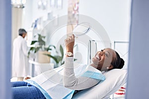 Smile, mirror and black woman at dentist on chair in clinic, tooth treatment and cleaning. Reflection, dental