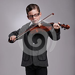 Smile, music and kid with violin in studio for practice with suit and glasses for fashion. Happy, style and cute young