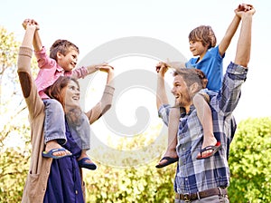 Smile, nature and kids on parents shoulders in outdoor park or field for playing together. Happy, bonding and young