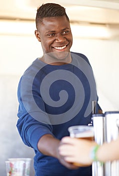 Smile, party and a black man bartender serving drinks outdoor at an event, festival or celebration. Beer, alcohol and