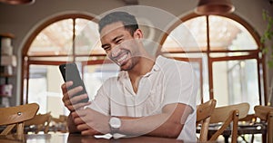 Smile, phone and man in coffee shop networking on social media, mobile app or the internet. Happy, technology and young