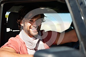 Smile, portrait and man in car on road trip with freedom, travel and desert adventure for summer vacation. Transport