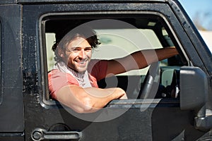 Smile, portrait and man in van on road trip with freedom, travel and desert adventure for summer vacation. Transport