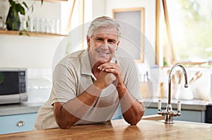 Smile, portrait and senior man in kitchen home alone in retirement. Relax, retired and elderly happy male from Canada in