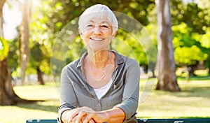 Smile, portrait and senior woman outdoor in park, garden and nature for wellness and relax on bench in summer. Happy