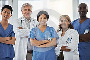 Smile, portrait and team of doctors with arms crossed standing together in hospital. Face, confident or medical