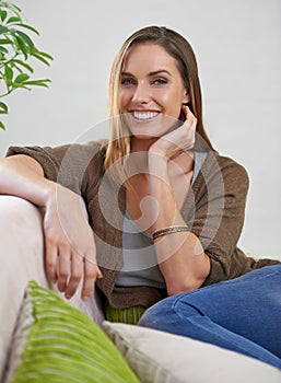 Smile, portrait and woman on couch to relax for comfort or rest on Saturday afternoon, peace and unwind. Female person