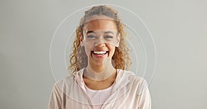 Smile, portrait and woman in studio with laughter for comedy, joke and funny humour on gray background. Female person