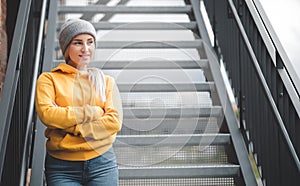 Smile portrait of a young woman looking to side. Outdoors daylight. Half length of cute girl wearing casual clothing