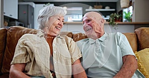 Smile, relax and senior couple watching tv together on sofa in living room of home for retirement. Television, movie or