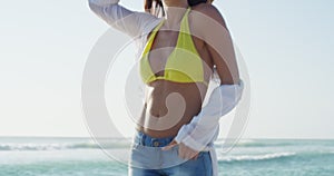Smile, relax and woman walking at the beach on holiday, vacation or travel in summer with hat. Happy person at ocean