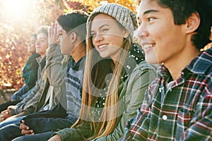 Smile, row and friends outdoor in park for relaxing day on summer vacation of semester break, together and happiness photo