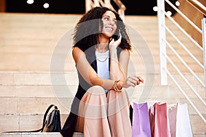 Smile, shopping phone call and woman at a mall for a sale, fashion and retail with a phone. Ecommerce, happy and