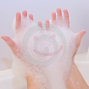 Smile on soap foam on hands