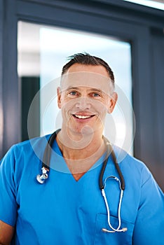 Smile, surgeon and portrait of mature man in a hospital at a cardiology clinic with confidence. Professional, medical