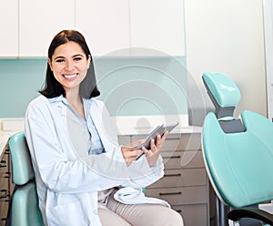 Smile, tablet and portrait of woman dentist with confidence in her office doing research at clinic. Happy, medical and