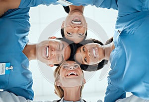 Smile, teamwork or faces of doctors in huddle laughing in collaboration together for healthcare goals. Low angle, funny