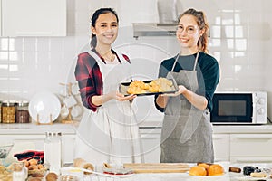 Smile two women dough bake cookies in kitchen