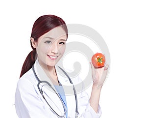 Smile woman doctor hold tomato