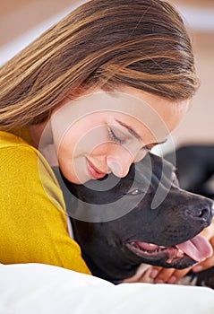 Smile, woman and dog on couch for relax, love and happiness together in living room. Female person, cuddle and puppy on