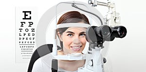 Smile woman doing eyesight measurement with slit lamp and visual