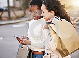 Smile, women and typing on smartphone for online shopping, sale or retail together outdoor by mall. Happy people, paper