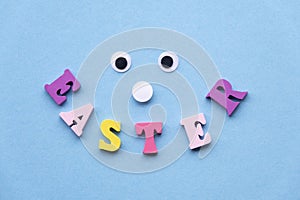 Smile from wooden colored letters on a light blue background. Sweet face.