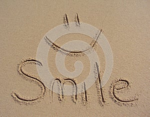 Smile written in the sand