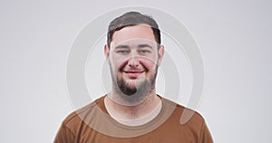 Smile, young and face of a man on a white background to relax with comedy or funny with mockup. Happy, laughing and