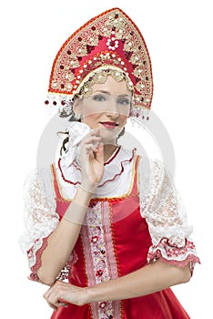 Smile young woman hands on hips portrait in russian traditional costume -- red sarafan and kokoshnik.