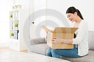 Smile young woman open cardboard parcel box