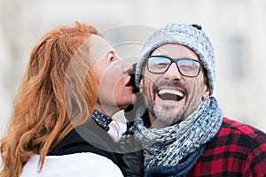 Smiled guy listen to woman. Very happy man from woman story. Woman whispers to man in glasses. Close up of man opened mouth.