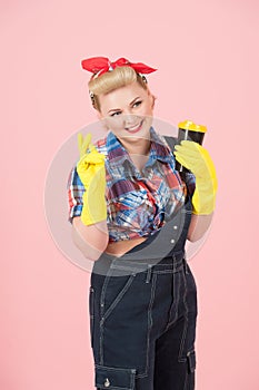 Smiled young girl and cup in hands. Beautiful pin-up styled woman say hello with pleasant smile