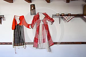 Smilen, Bulgaria - Indoor interior of old bulgarian house, ethnography, traditional costumes from Bulgaria, hanged on a wall