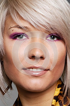 Smiley blond with piercing in eyebrow