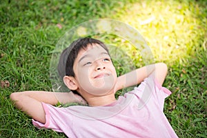 Smiley boy laying down in the park