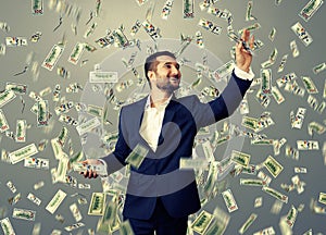 Smiley businessman catching money