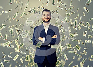 Smiley businessman under dollar's rain