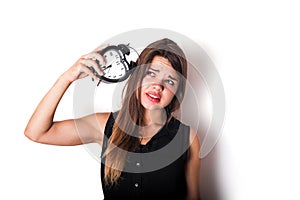 smiley businesswoman holding alarm clock