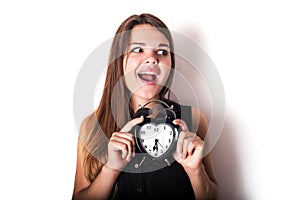 Smiley businesswoman holding alarm clock