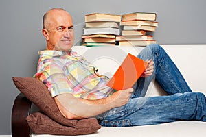 Smiley elderly man reading interesting book