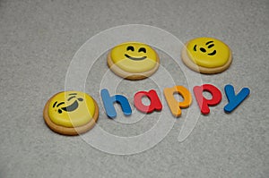 Smiley emojies biscuit with the word happy