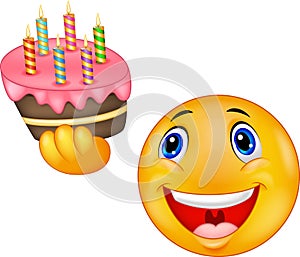 Smiley emoticon holding birthday cake