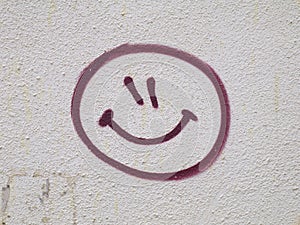 Smiley face graffiti drawn on wall